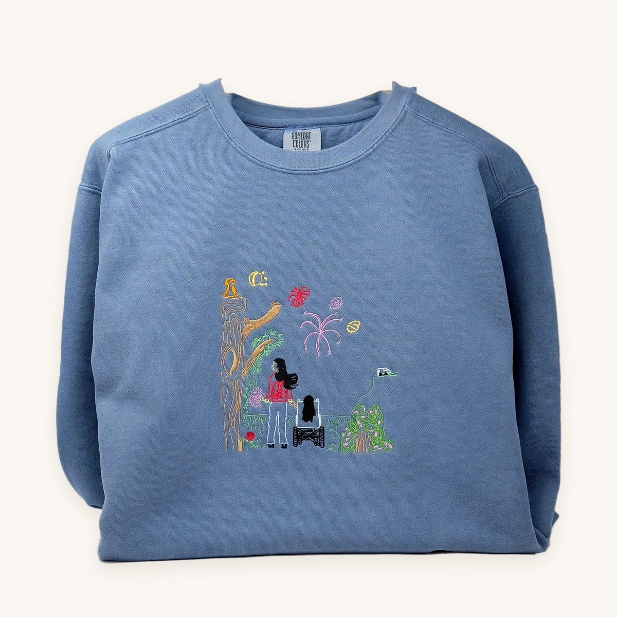Child's drawing embroidered on a blue crewneck sweatshirt