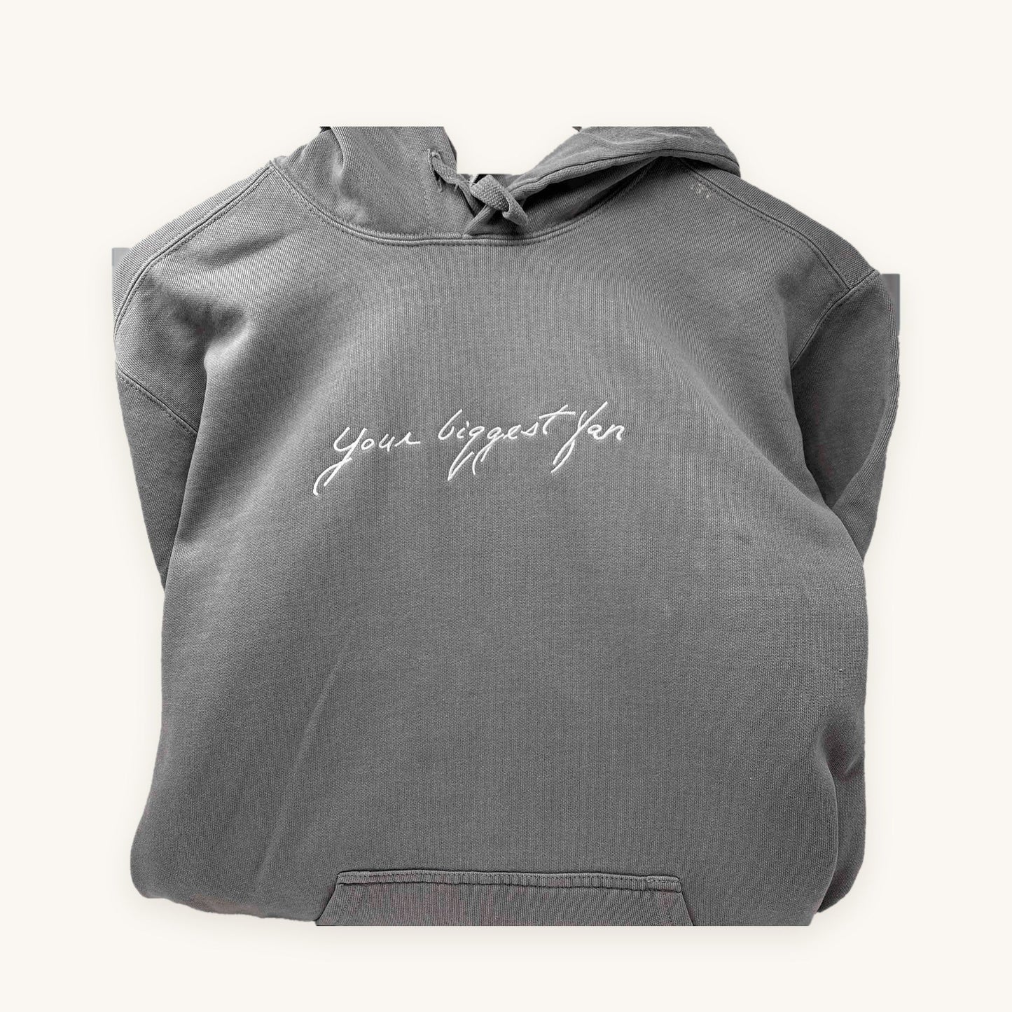 A loved one's handwriting embroidered on a grey hoodie